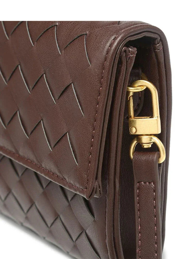 Close-up of Alba's gold-tone toggle fastening and knot tie detail